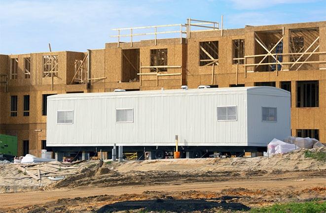 workers studying blueprints in a temporary rental office in North Royalton OH